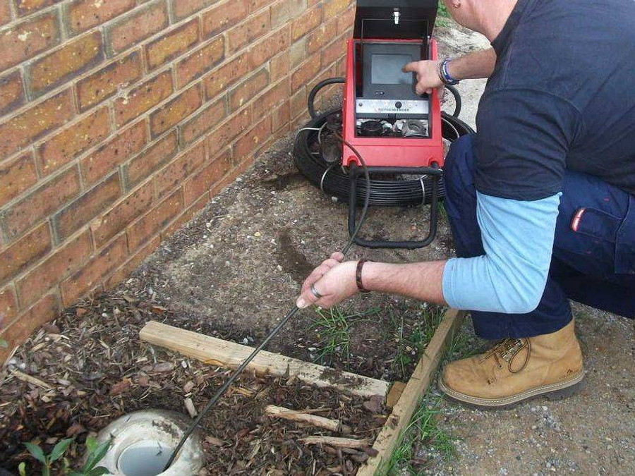 A&A technician performing a video inspection of a residential sewer line